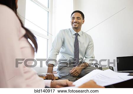 Stock Photo - Business people talking in office. Fotosearch