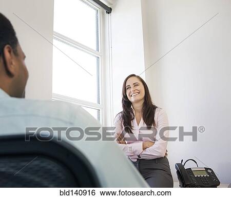 Stock Photograph - Business people talking in office. Fotosearch