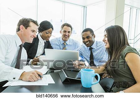 Business people using laptop computer in meeting View Large Photo Image Stock Photograph - Business people using laptop computer in meeting. Fotosearch