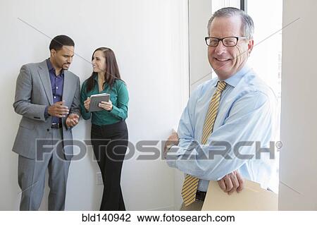 Stock Image - Business people working in office. Fotosearch