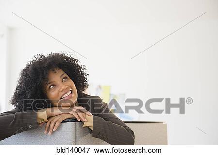 Businesswoman leaning over cubicle wall in office View Large Photo Image Stock Photo - Businesswoman leaning over cubicle wall in office. Fotosearch