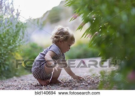 Caucasian baby boy exploring in garden View Large Photo Image Picture - Caucasian baby boy exploring in garden. Fotosearch