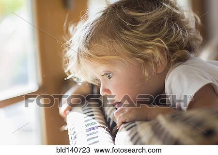 Caucasian baby boy peering over back of sofa in living room View Large Photo Image Stock Image - Caucasian baby boy peering over back of sofa in living room. Fotosearch