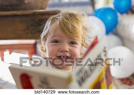 Caucasian baby boy playing with book View Large Photo Image Stock Photo - Caucasian baby boy playing with book. Fotosearch