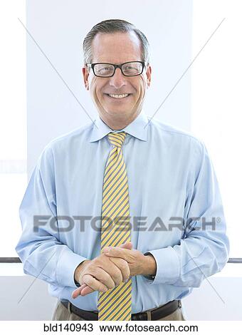 Caucasian businessman rubbing his hands in office View Large Photo Image Stock Image - Caucasian businessman rubbing his hands in office. Fotosearch