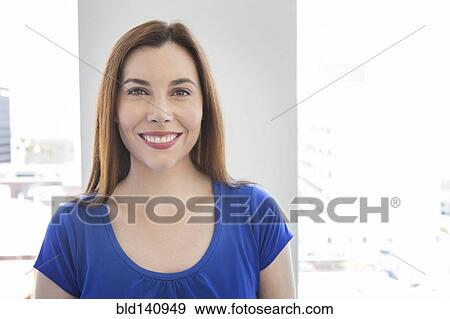 Stock Photo - Caucasian businesswoman smiling in office. Fotosearch