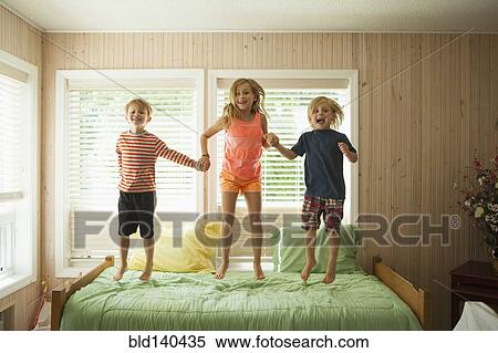 Caucasian children jumping on bed View Large Photo Image Stock Photography - Caucasian children jumping on bed. Fotosearch
