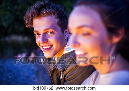 Caucasian couple relaxing together on beach at night View Large Photo Image Stock Image - Caucasian couple relaxing together on beach at night. Fotosearch