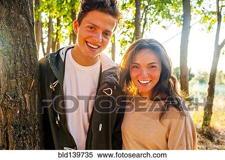 Caucasian couple smiling in park View Large Photo Image Stock Photography - Caucasian couple smiling in park. Fotosearch