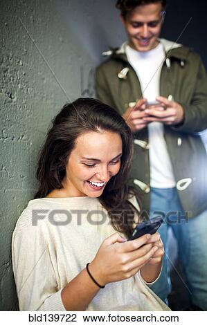 Caucasian couple using cell phones together in tunnel View Large Photo Image Stock Image - Caucasian couple using cell phones together in tunnel. Fotosearch