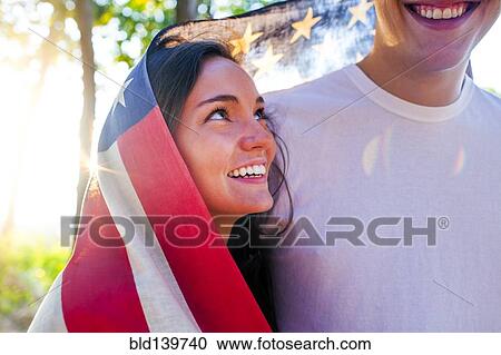 Caucasian couple wrapped in American flag View Large Photo Image Stock Image - Caucasian couple wrapped in American flag. Fotosearch