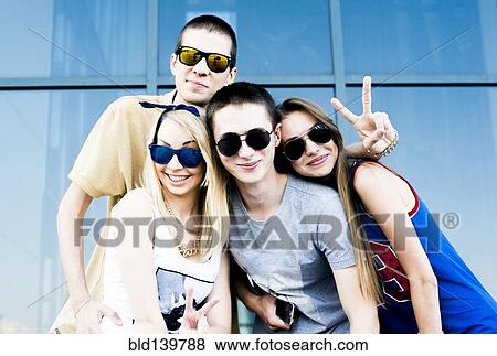 Stock Photo - Caucasian couples smiling near window. Fotosearch