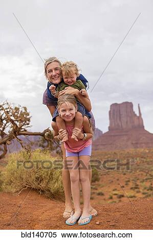Caucasian family smiling in desert, Monument Valley, Utah, United States View Large Photo Image Stock Photography - Caucasian family smiling in desert, Monument Valley, Utah, United States. Fotosearch