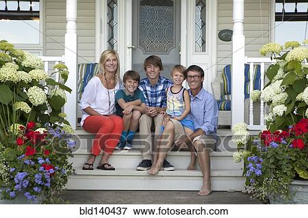 Caucasian family smiling on front porch View Large Photo Image Stock Photo - Caucasian family smiling on front porch. Fotosearch