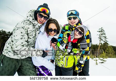 Caucasian friends smiling in snow View Large Photo Image Stock Photo - Caucasian friends smiling in snow. Fotosearch