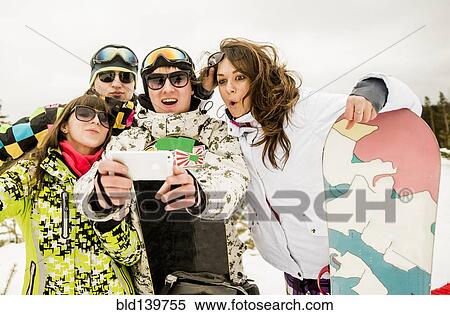 Caucasian friends with snowboard taking selfie View Large Photo Image Stock Photography - Caucasian friends with snowboard taking selfie. Fotosearch