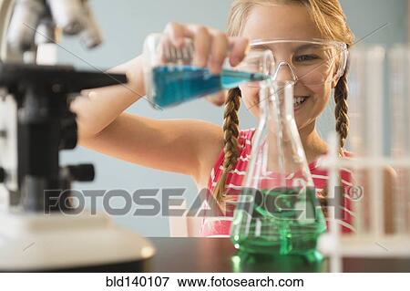 Stock Photo - Caucasian girl doing science experiment in lab. Fotosearch