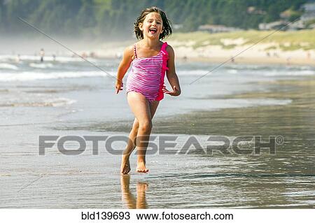 Caucasian girl playing in surf on beach View Large Photo Image Stock Image - Caucasian girl playing in surf on beach. Fotosearch