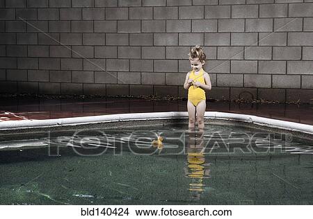 Caucasian girl standing in swimming pool View Large Photo Image Picture - Caucasian girl standing in swimming pool. Fotosearch