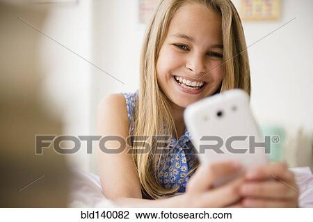 Caucasian girl using cell phone View Large Photo Image Stock Image - Caucasian girl using cell phone. Fotosearch
