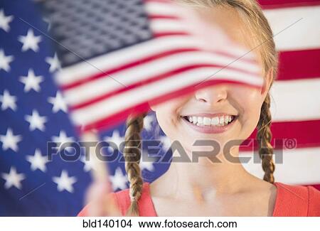 Picture - Caucasian girl waving American flag. Fotosearch