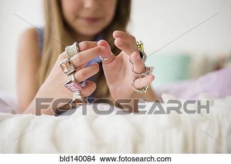 Picture - Caucasian girl wearing costume rings. Fotosearch