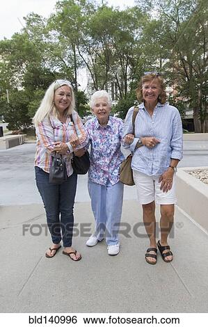 Stock Photograph - Caucasian mother and daughters walking together. Fotosearch