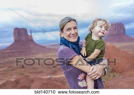 Caucasian mother holding baby son in desert, Monument Valley, Utah, United States View Large Photo Image Stock Image - Caucasian mother holding baby son in desert, Monument Valley, Utah, United States. Fotosearch