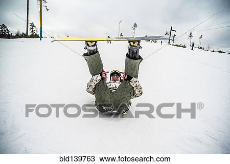 Caucasian snowboarder laying in snow with legs raised View Large Photo Image Stock Image - Caucasian snowboarder laying in snow with legs raised. Fotosearch