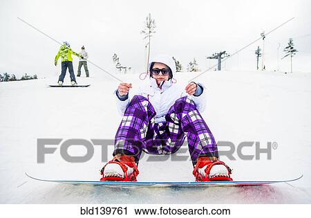 Caucasian snowboarder sitting in snow View Large Photo Image Stock Image - Caucasian snowboarder sitting in snow. Fotosearch