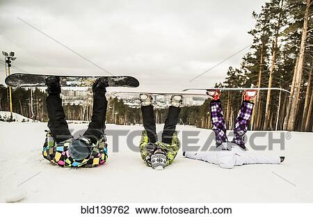 Caucasian snowboarders laying in snow with legs raised View Large Photo Image Stock Image - Caucasian snowboarders laying in snow with legs raised. Fotosearch