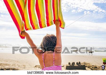 Caucasian woman holding towel in wind on beach View Large Photo Image Stock Photography - Caucasian woman holding towel in wind on beach. Fotosearch