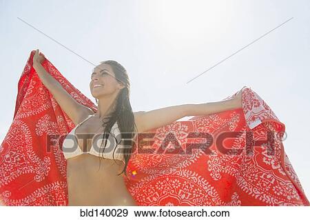Caucasian woman holding towel outdoors View Large Photo Image Stock Photo - Caucasian woman holding towel outdoors. Fotosearch