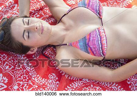 Caucasian woman laying on beach View Large Photo Image Stock Photograph - Caucasian woman laying on beach. Fotosearch