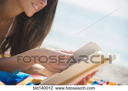 Caucasian woman reading book on beach View Large Photo Image Stock Image - Caucasian woman reading book on beach. Fotosearch