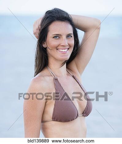 Stock Photo - Caucasian woman smiling in bikini. Fotosearch