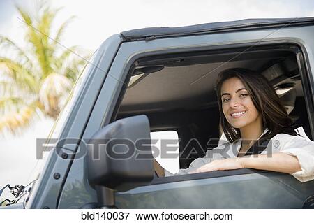 Caucasian woman smiling in car View Large Photo Image Stock Photo - Caucasian woman smiling in car. Fotosearch