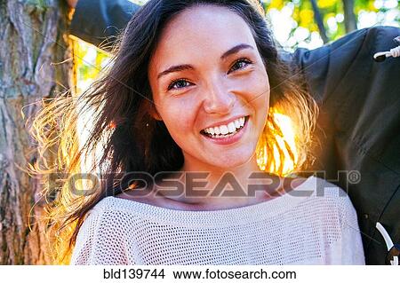 Caucasian woman smiling outdoors View Large Photo Image Picture - Caucasian woman smiling outdoors. Fotosearch