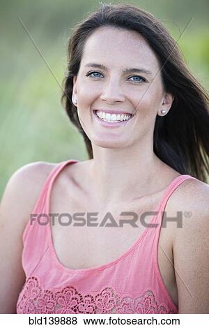 Stock Photo - Caucasian woman smiling outdoors. Fotosearch