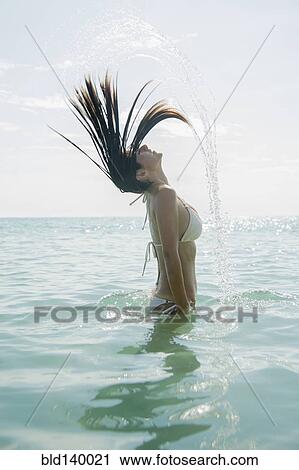 Caucasian woman splashing hair in ocean View Large Photo Image Stock Image - Caucasian woman splashing hair in ocean. Fotosearch