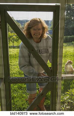 Caucasian woman standing near chicken coop View Large Photo Image Stock Image - Caucasian woman standing near chicken coop. Fotosearch