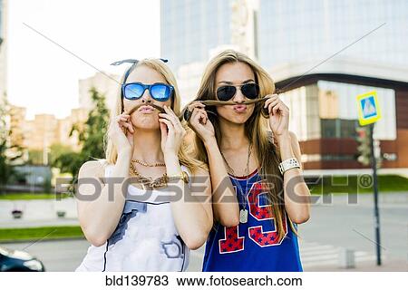 Caucasian women making faces in city View Large Photo Image Stock Image - Caucasian women making faces in city. Fotosearch
