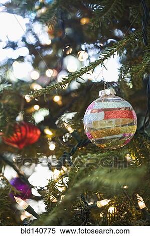 Close up of ornaments hanging on Christmas tree View Large Photo Image Stock Photography - Close up of ornaments hanging on Christmas tree. Fotosearch