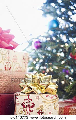 Close up of wrapped gifts under Christmas tree View Large Photo Image Stock Image - Close up of wrapped gifts under Christmas tree. Fotosearch