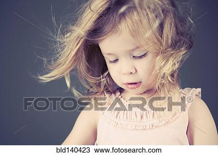 Stock Image - Girl looking down. Fotosearch