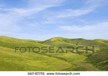 Hills and blue sky in rolling landscape View Large Photo Image Stock Photography - Hills and blue sky in rolling landscape. Fotosearch