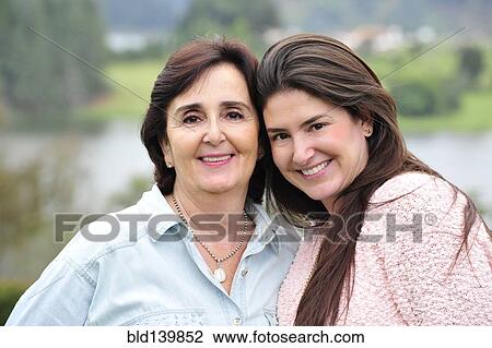 Stock Image - Hispanic mother and daughter smiling together. Fotosearch