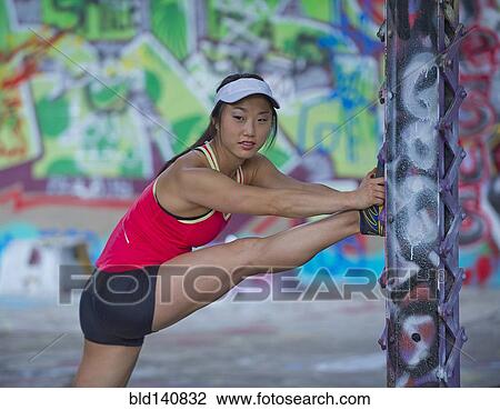 Korean runner stretching on column with graffiti View Large Photo Image Stock Image - Korean runner stretching on column with graffiti. Fotosearch