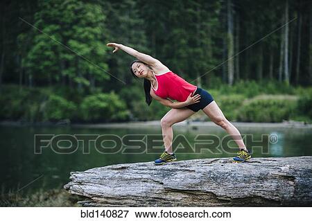 Korean runner stretching on rock near lake View Large Photo Image Stock Photo - Korean runner stretching on rock near lake. Fotosearch