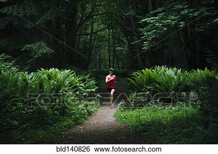 Korean woman running in lush forest View Large Photo Image Stock Photograph - Korean woman running in lush forest. Fotosearch